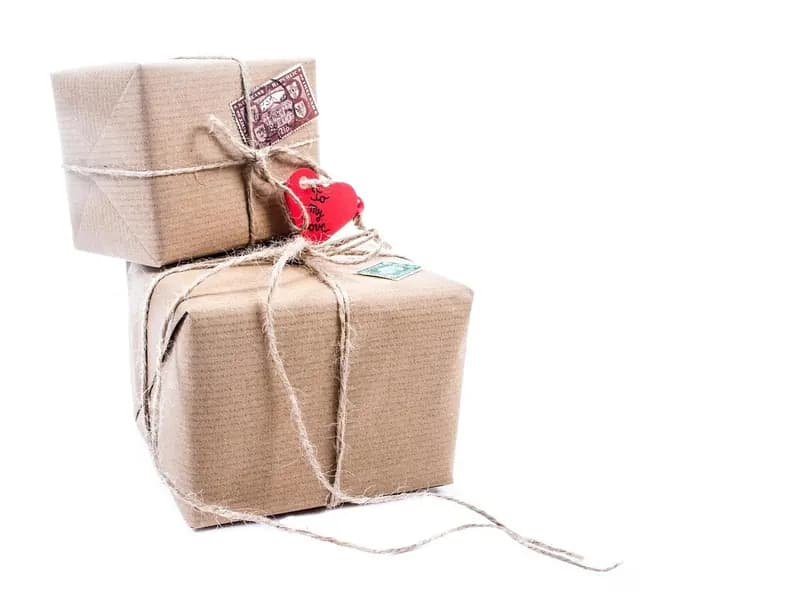 Two parcels wrapped in plain paper and tied with string, ready to be dispatched.