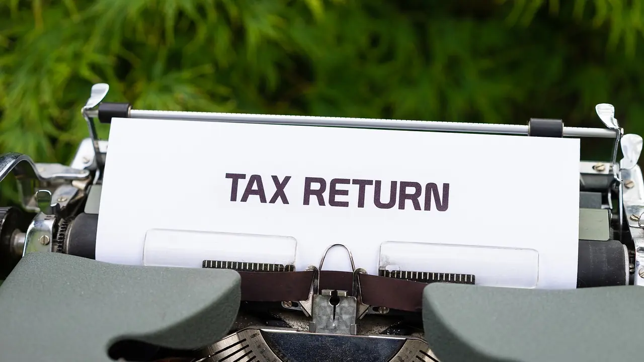 A sheet headed “Tax Return” rolled into a typewriter.